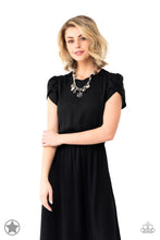 Load image into Gallery viewer, Black and ivory cording is braided through a chunky silver chain. A unique variety of charms decorate the piece including a delicate flower and a heart. Heart is inscribed with the phrase "With All My Heart"on one side and a short bible verse on the other that reads, "Love the Lord thy God with all your heart. Luke 10:27." Features an adjustable clasp closure.