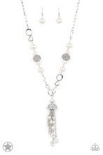 Load image into Gallery viewer, A half-shell studded in rhinestones overhangs a cluster of ivory pearls, tassels of silver chain, and small crystals. Two large wire mesh spheres and larger ivory pearls decorate the neckline.
