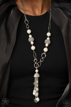 Load image into Gallery viewer, A half-shell studded in rhinestones overhangs a cluster of ivory pearls, tassels of silver chain, and small crystals. Two large wire mesh spheres and larger ivory pearls decorate the neckline.