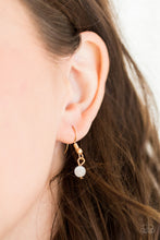 Load image into Gallery viewer, Shimmery gold bars curl around a glowing teardrop moonstone, creating an elegant heart shaped pendant below the collar. Features an adjustable clasp closure.