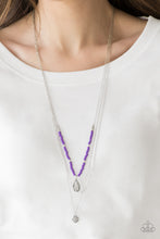 Load image into Gallery viewer, MILD WILD - PURPLE - Paparazzi Infused with vivacious purple beading and an ornate silver teardrop pendant, a colorfully beaded strand gives way to a plain silver chain and a dainty silver chain featuring an antiqued pendant for a whimsically layered look. Features an adjustable clasp closure. Includes one pair of matching earrings.