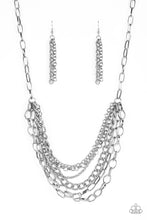 Load image into Gallery viewer, Mismatched silver chains layer below the collar for a bold industrial look. Painted in a neutral finish, a shiny gray chain drapes between the shimmery silver chains for a vivacious finish. Features an adjustable clasp closure. Sold as one individual necklace by Paparazzi. Includes one pair of matching earrings.
