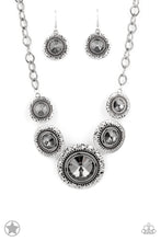 Load image into Gallery viewer, Gradually increasing in size, dramatically oversized smoky gems are pressed into the centers of hammered and silver studded frames. The blinding frames link below the collar for a glamorous, statement-making finish. Features an adjustable clasp closure. Sold as one individual necklace. Includes one pair of matching earrings