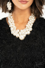 Load image into Gallery viewer, Zi Collection 2020 - An exaggerated display of clustered pearls elegantly sweeps below the collar. The classic white pearls gradually increase in bubbly intensity as they reach the center of the regal piece, adding over-the-top timelessness to the unapologetic pearl palette. Features an adjustable clasp closure. Sold as one individual necklace. Includes one pair of matching earrings.