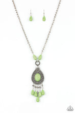 Load image into Gallery viewer, Paparazzi - Cowgirl Couture - Green - An Apple Green oval stone sits center stage surrounded by swirly designs stamped into a wide silver frame. A fringe of silver floral beads culminating in Apple Green stones swings like a pendulum at the end of a lengthened silver chain for a fashionable finish.