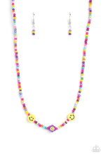 Load image into Gallery viewer, Paparazzi - Flower Power Pageant - Purple - Multicolored seed beads, featuring lavender, green, pink, pearly pink, blue, orange, purple, yellow, and dark green, are threaded along a wire, falling along the collar in a capricious pattern. Bringing additional charm to the design, yellow smiley face beads, and a purple flower with a yellow smiley face center, blooms amongst the bright pops of color.