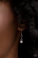 Load image into Gallery viewer, Hypnotic Twinkle - White - Dusted in sections of glassy white rhinestones, asymmetrical silver frames curl around oversized white gems below the collar. Varying in shape, the mismatched frames increase in size as they near the center for a hypnotizing finish. - Paparazzi