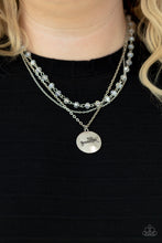 Load image into Gallery viewer, Promoted to Grandma - White - Paparazzi - Infused with a strand of iridescent crystal-like beads, two dainty rows of mismatched silver chains delicately layer below the collar. Stamped in the word, "Grandma," a shiny silver disc swings from the lowest chain, creating a loving pendant.