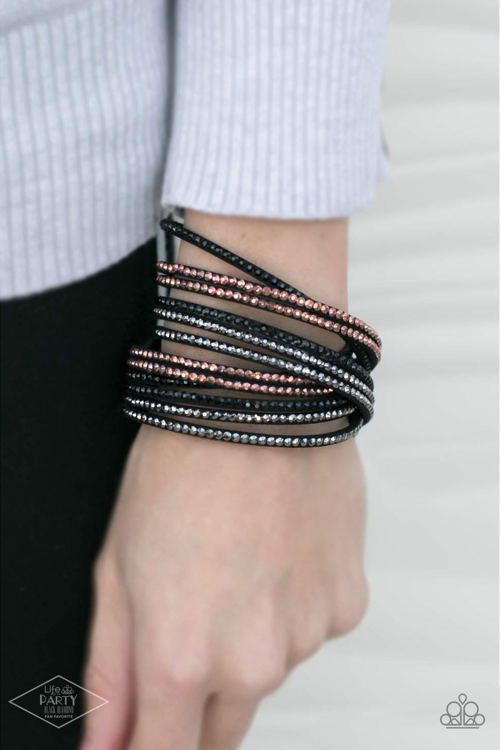 Black suede is spliced into six strands and embellished with rows of black, hematite, and metallic rhinestones brushed in a copper finish for a glitzy combination. The elongated leather band allow for a trendy double wrap design. Features an adjustable snap closure.  Sold as one individual bracelet. CAN BE WORN AS A CHOKER NECKLACE AS WELL!