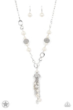 Load image into Gallery viewer, A half-shell studded in rhinestones overhangs a cluster of ivory pearls, tassels of silver chain, and small crystals. Two large wire mesh spheres and larger ivory pearls decorate the neckline.
