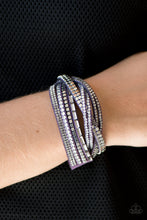 Load image into Gallery viewer, A mishmash of smoky and white rhinestones, flat silver beads and sparkling emerald-cut gems are sprinkled along strands of purple suede for a sassy look. The elongated design allows for a trendy double wrap around the wrist. Features an adjustable snap closure.

