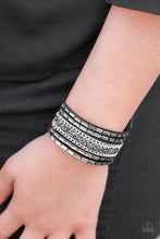 Load image into Gallery viewer, Featuring prism and emerald style cuts, black and hematite rhinestones are sprinkled along rows of shimmery black suede, creating sassy shimmer around the wrist. Features an adjustable snap closure.
