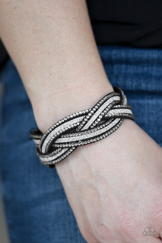 Dusted in glitter, skinny black strands braid with rhinestone encrusted strands across the wrist for a sassy look. Features an adjustable snap closure.