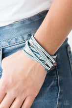 Load image into Gallery viewer, Encrusted in rows of glassy white rhinestones and flat silver studs, three strands of blue suede wrap around the wrist for a sassy look. The elongated band allows for a trendy double wrap around the wrist. Features an adjustable snap closure
