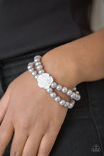 Load image into Gallery viewer, Connected by a flirty white resin rose, classic silver pearls are threaded along stretchy bands around the wrist for a vintage inspired fashion. $5 JEWELRY
