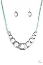 Load image into Gallery viewer, Strands of blue suede knot around interconnecting silver links, creating a bold pendant below the collar. Features an adjustable clasp closure
