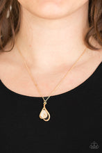 Load image into Gallery viewer, Shimmery gold bars curl around a glowing teardrop moonstone, creating an elegant heart shaped pendant below the collar. Features an adjustable clasp closure.
