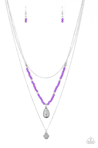 MILD WILD - PURPLE - Paparazzi Infused with vivacious purple beading and an ornate silver teardrop pendant, a colorfully beaded strand gives way to a plain silver chain and a dainty silver chain featuring an antiqued pendant for a whimsically layered look. Features an adjustable clasp closure. Includes one pair of matching earrings.