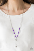 Load image into Gallery viewer, MILD WILD - PURPLE - Paparazzi Infused with vivacious purple beading and an ornate silver teardrop pendant, a colorfully beaded strand gives way to a plain silver chain and a dainty silver chain featuring an antiqued pendant for a whimsically layered look. Features an adjustable clasp closure. Includes one pair of matching earrings.
