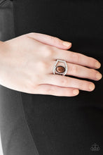 Load image into Gallery viewer, A pearly brown bead sits between two white rhinestone encrusted bands, creating the illusion of a floating centerpiece. Features a stretchy band for a flexible fit.  Sold as one individual ring by Paparazzi.
