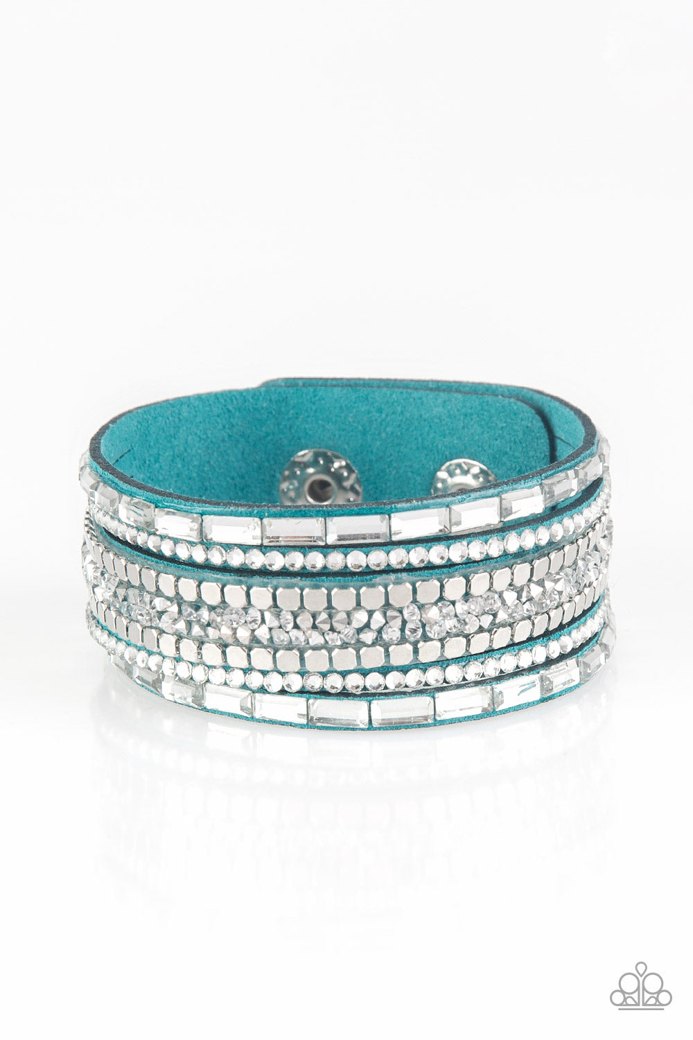 Featuring round and emerald style cuts, glassy white rhinestones join flat silver cubes and metallic prism rhinestones along a blue suede band for a sassy look. Features an adjustable snap closure.