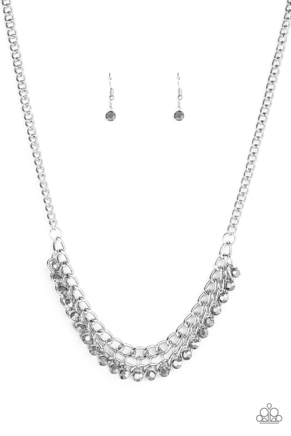A fringe of glittery hematite rhinestones swings from the bottom of a bold silver chain below the collar for a fierce look. Features an adjustable clasp closure.