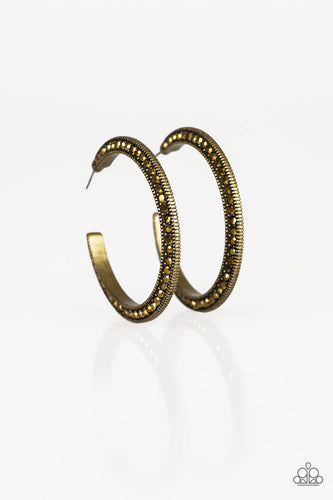 Both sides of a studded brass hoop are encrusted in golden aurum rhinestones for an edgy dazzle. Earring attaches to a standard post fitting. Hoop measures 1 1/2