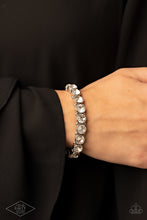 Load image into Gallery viewer, Sugar-Coated Sparkle - White - Paparazzi - Infused with dainty silver beads, glassy white rhinestone encrusted frames are threaded along stretchy bands around the wrist for a glamorous look.
