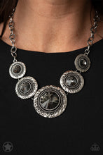 Load image into Gallery viewer, Gradually increasing in size, dramatically oversized smoky gems are pressed into the centers of hammered and silver studded frames. The blinding frames link below the collar for a glamorous, statement-making finish. Features an adjustable clasp closure.  Sold as one individual necklace. Includes one pair of matching earrings

