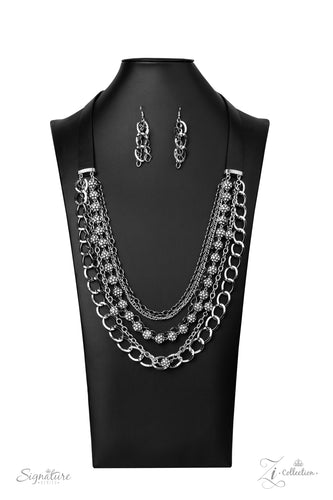 Attached to two strips of black leather, strands of bedazzled white rhinestone encrusted silver beads drape between an exaggerated display of mismatched silver and gunmetal chains down the chest. With its edgy sparkle, grunge meets glamour in this heart-stopping statement-maker. Features an adjustable clasp closure.