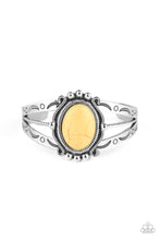 Load image into Gallery viewer, A twisted silver bar is flanked by two silver bands stamped in artisan inspired patterns, coalescing into an airy cuff. Pressed into the center of a decorative silver frame, a sunny yellow stone sits atop the stacked cuff for an earthy finish.
