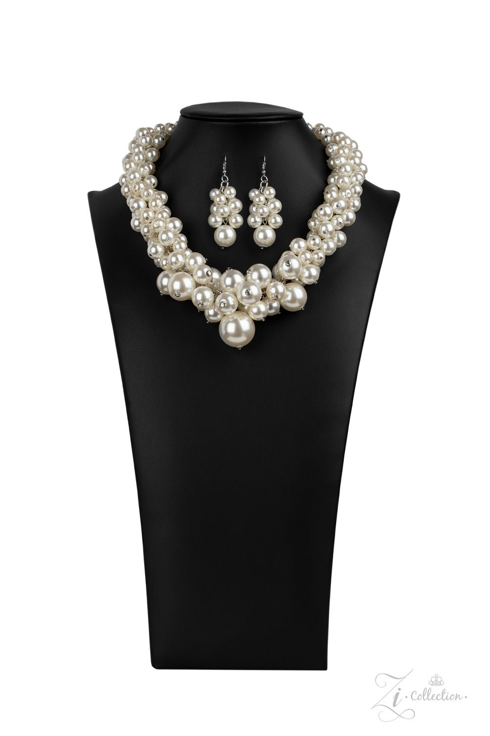Zi Collection 2020 - An exaggerated display of clustered pearls elegantly sweeps below the collar. The classic white pearls gradually increase in bubbly intensity as they reach the center of the regal piece, adding over-the-top timelessness to the unapologetic pearl palette. Features an adjustable clasp closure.  Sold as one individual necklace. Includes one pair of matching earrings. 