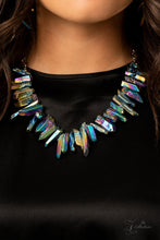Load image into Gallery viewer, Featuring an oil spill iridescence, raw cut pieces of hematite are threaded along an invisible wire below the collar for a colorfully courageous look. Features an adjustable clasp closure.
