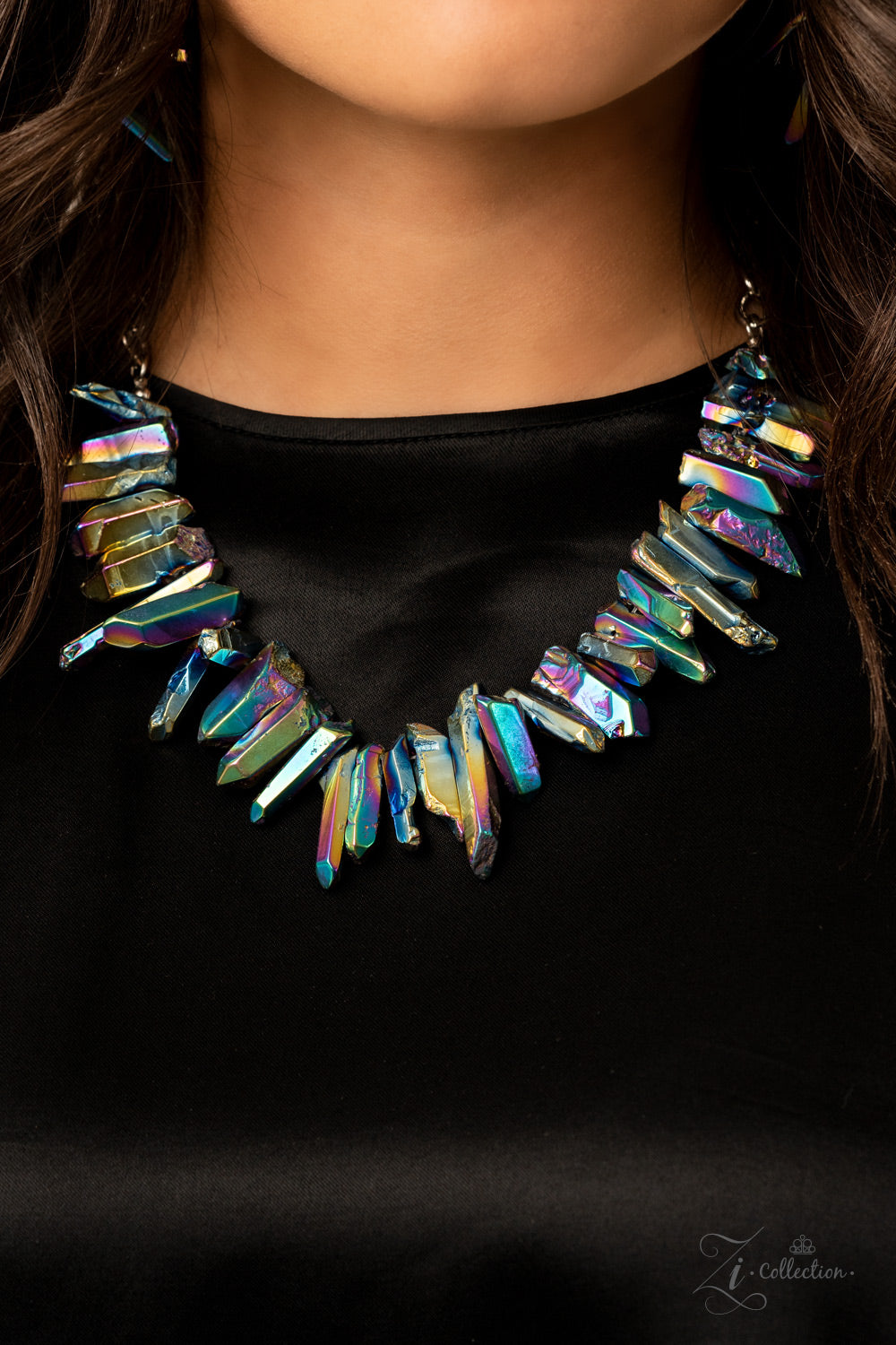 Featuring an oil spill iridescence, raw cut pieces of hematite are threaded along an invisible wire below the collar for a colorfully courageous look. Features an adjustable clasp closure.