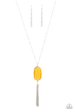 Load image into Gallery viewer, Featuring a faceted surface, a dewy yellow acrylic gem swings from the bottom of a lengthened silver chain. A shimmery silver chain tassel attaches to the bottom of the colorful pendant, adding flirtatious movement. Features an adjustable clasp closure.
