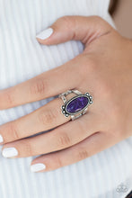 Load image into Gallery viewer, An elongated oval purple stone is pressed into the center of a textured silver frame dotted with antiqued silver studs, creating a tranquil centerpiece atop the finger. Features a stretchy band for a flexible fit.
