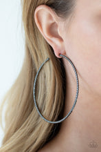 Load image into Gallery viewer, Etched and hammered in striking texture, a shimmery gunmetal bar delicately curls into a dramatically oversized hoop. Earring attaches to a standard post fitting. Hoop measures approximately 3&quot; in diameter.
