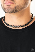 Load image into Gallery viewer, Sections of gunmetal beads and studded hexagonal accents are knotted in place along a black cord that has been braided around the neck for a seasonal look. Features a button loop closure.
