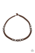 Load image into Gallery viewer, Sections of shiny silver beads and studded hexagonal accents are knotted in place along a brown cord that has been braided around the neck. Features a wooden toggle closure.
