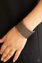 Load image into Gallery viewer, Twisted rows of antiqued copper wires layer between two flat copper bars, coalescing into a boldly stacked cuff around the wrist.
