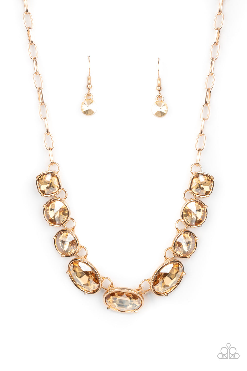 Featuring mismatched round, oval, and square cuts, a golden row of dramatically oversized rhinestones delicately link below the collar for an icy finish. Features an adjustable clasp closure.  Sold as one individual necklace. Includes one pair of matching earrings.