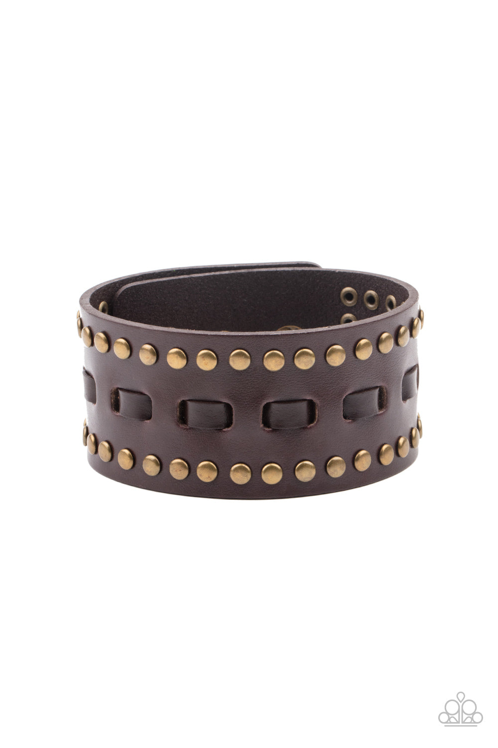 Brown laces are threaded through the center of a brown leather band that has been studded in brass accents, creating a rustic centerpiece around the wrist. Features an adjustable snap closure.