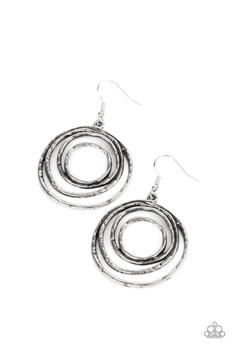 Brushed in an antiqued shimmer, hammered silver wire coils into a dizzying frame for an edgy industrial look. Earring attaches to a standard fishhook fitting.  Sold as one pair of earrings by Paparazzi.