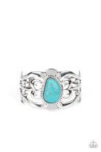 Load image into Gallery viewer, An asymmetrical turquoise stone is pressed into the center of a silver cuff layered with filigree patterns around the wrist for a rustic flair.
