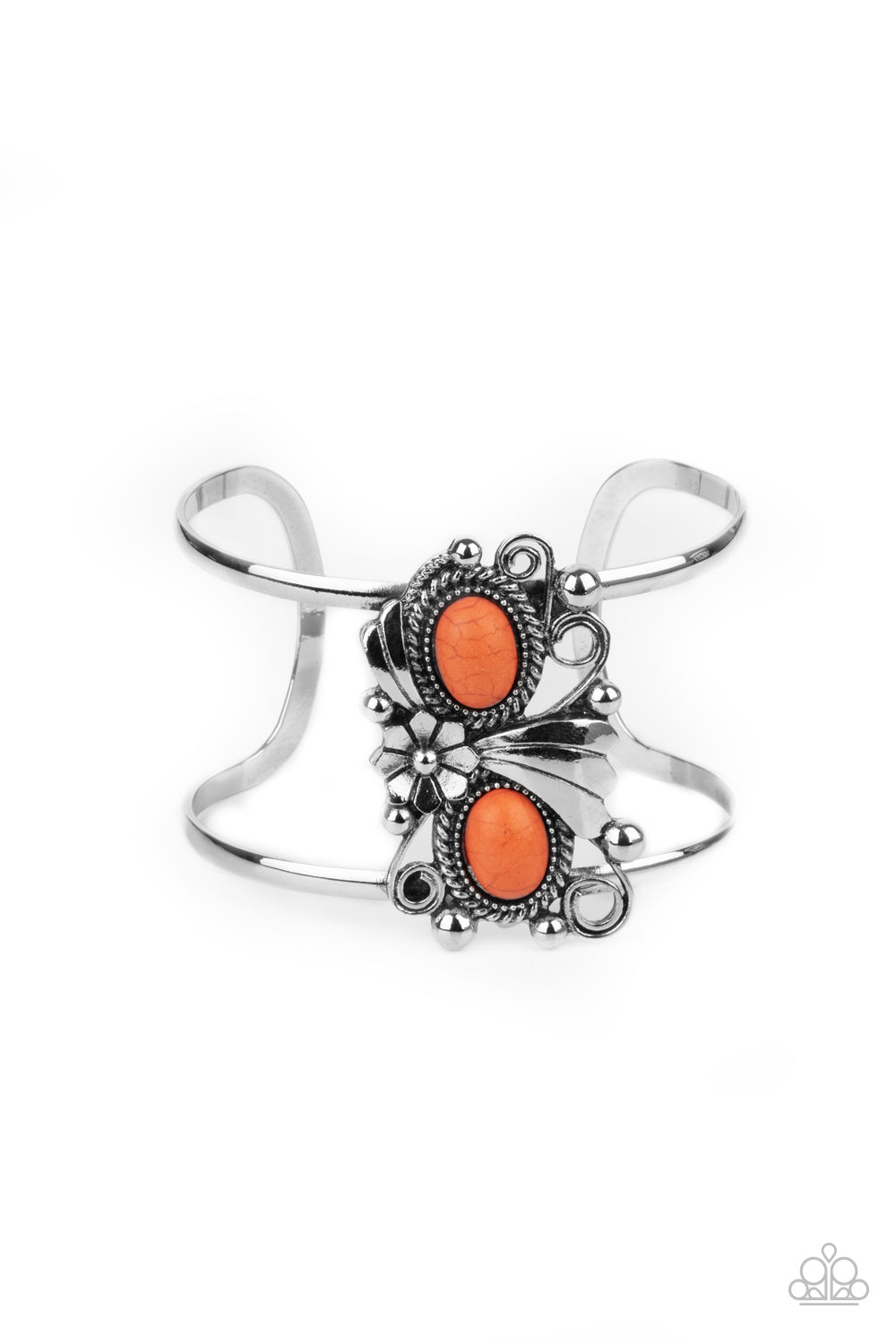 A leafy silver flower blooms between two oval orange stones atop a studded and filigree filled backdrop, creating a subtly slanted centerpiece across the airy silver cuff.