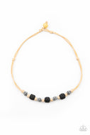 Decorative silver beads and pieces of black pumice-like rock are knotted in place below the collar for a seasonal look. Features a button loop closure.