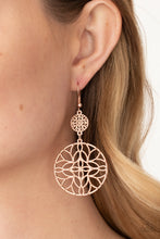 Load image into Gallery viewer, Featuring a stenciled mandala-like pattern, a studded rose gold frame swings from a dainty matching frame, creating a whimsical lure. Earring attaches to a standard fishhook fitting.
