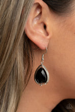 Load image into Gallery viewer, Featuring a reflective metallic back, a glittery black rhinestone gem is threaded along a rod inside a silver teardrop casing, creating a glamorous lure. Earring attaches to a standard fishhook fitting.
