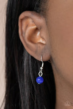 Load image into Gallery viewer, Attached to a decorative silver fitting, a dramatically oversized blue cat&#39;s eye stone pendant glides along a rounded silver snake chain below the collar for a powerful pop of color. Features an adjustable clasp closure.  Sold as one individual necklace by Paparazzi  Includes one pair of matching moonstone earrings.
