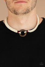 Load image into Gallery viewer, A wooden hoop is knotted in place between two glassy red beads along braided white cording around the neck for an earthy look. Features a button loop closure.
